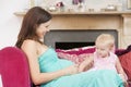 Pregnant mother with daughter in living room Royalty Free Stock Photo