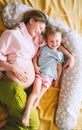 Pregnant mother and daughter together at home. Woman with her first child during second pregnancy. Motherhood and parenting Royalty Free Stock Photo