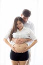 Pregnant Mother and father standing hugging holding belly heart shape with hand Royalty Free Stock Photo