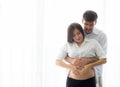 Pregnant Mother and father standing hugging holding belly heart shape with hand Royalty Free Stock Photo