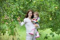 Pregnant mother and her baby daughter picking apples Royalty Free Stock Photo