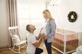 Pregnant Mother and her husband on the baby room at home Royalty Free Stock Photo