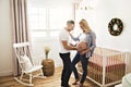 Pregnant Mother and her husband on the baby room at home Royalty Free Stock Photo