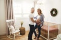 Pregnant Mother and her husband on the baby room at home Royalty Free Stock Photo