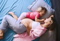 Pregnant mother with her little daughter relaxing in bed. Second pregnancy. Maternity and parenting concept Royalty Free Stock Photo