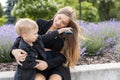 Pregnant mother and her little son spending time together in the park, hugging and smiling Royalty Free Stock Photo