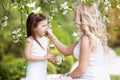 Pregnant mother and her small daughter have fun outdoor. Family look Royalty Free Stock Photo