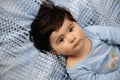 Pregnant Mother laying with her baby son on the bedroom bed playing and having fun - Asian mixed ethnicity child Boy Royalty Free Stock Photo