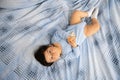 Pregnant Mother laying with her baby son on the bedroom bed playing and having fun - Asian mixed ethnicity child Boy Royalty Free Stock Photo