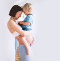 Pregnant mother and son at home. Royalty Free Stock Photo