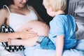 Pregnant mother and son at home. Royalty Free Stock Photo