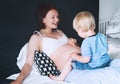 Pregnant mother and son at home. Royalty Free Stock Photo