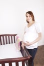 Pregnant Mother standing by a crib Royalty Free Stock Photo