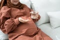 Pregnant Muslim Woman Taking Folic Acid Pill