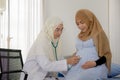 Pregnant muslim woman with her muslim female doctor in clinic, Gynaecology consultation Royalty Free Stock Photo