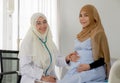 Pregnant muslim woman with her muslim female doctor in clinic, Gynaecology consultation Royalty Free Stock Photo