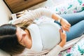 Pregnant pain contractions. Pregnant woman watching clock, holding baby belly. Childbirth time, contractions pain Royalty Free Stock Photo