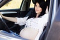 Pregnant pretty girl is sitting in car