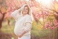 Pregnant pretty woman in spring blossom garden Royalty Free Stock Photo