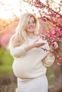 Pregnant pretty woman in spring blossom garden Royalty Free Stock Photo