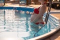 Pregnant red-haired woman in the pool in a red bikini. Royalty Free Stock Photo