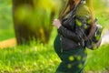 Pregnant schoolgirl. Attractive pregnant woman in dress schoolgirl posing on the street. Long-haired pregnant woman walking down