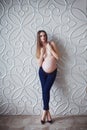 Pregnant skinny women model in business office style cloth topless