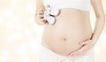 Pregnant Stomach and Newborn Baby Booties, Woman Showing Belly Royalty Free Stock Photo