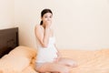 Pregnant suffering with nausea. Pregnancy symptoms, expectation toxicosis. Young vomiting woman sitting on bed. parenthood concept Royalty Free Stock Photo