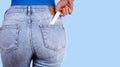 Woman with pregnancy test in pocket jeans Royalty Free Stock Photo