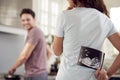 Pregnant Transgender Couple At Home In Kitchen With Woman Surprising Man With Ultrasound Scan Of Baby Royalty Free Stock Photo