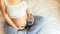 Pregnant water drinking woman. Young pregnancy mother drink water. Pregnant lady waiting of baby. Glass of water Royalty Free Stock Photo