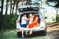 Pregnant wife, husband and dog sitting in a car Royalty Free Stock Photo