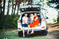 Pregnant wife, husband and dog sitting in a car Royalty Free Stock Photo