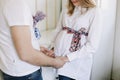 Pregnant wife with husband. Man touching belly of pregnant woman. Family couple waiting for baby. Royalty Free Stock Photo