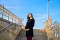 Pregnant woman against the blue sky. Portrait of a young pregnant woman against a clear blue sky, urban pregnancy, beautiful and Royalty Free Stock Photo