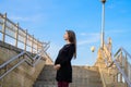 Pregnant woman against the blue sky. Portrait of a young pregnant woman against a clear blue sky, urban pregnancy, beautiful and Royalty Free Stock Photo