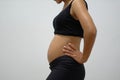 a pregnant woman aged 3 months wearing a black tank top Royalty Free Stock Photo