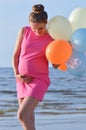 Pregnant woman with air balloons