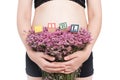 pregnant woman and alphabet blocks spelling GIRL on white background