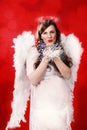 Pregnant woman with angel costume Royalty Free Stock Photo