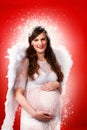 Pregnant woman with angel costume Royalty Free Stock Photo