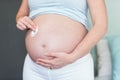 Pregnant woman applying cream on her belly Royalty Free Stock Photo