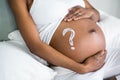 Pregnant woman applying cream on her belly Royalty Free Stock Photo