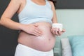 Pregnant woman applying cream to her belly Royalty Free Stock Photo