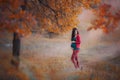 Pregnant woman in the autumn forest. Autumn portrait. Pregnancy, maternity, expectation concept. Beautiful tender mood photo of pr