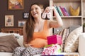 Pregnant woman with baby shoes Royalty Free Stock Photo