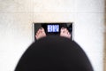 Pregnant woman on a bathroom scale. Weight in pregnancy Royalty Free Stock Photo