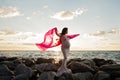 Pregnant Woman on the Beach with Pink Veil Royalty Free Stock Photo