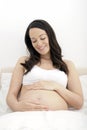 Pregnant woman in bed Royalty Free Stock Photo